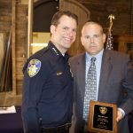 Vallejo police Chief Andrew Bidou, left, presents Detective Mat Mustard with the department's 