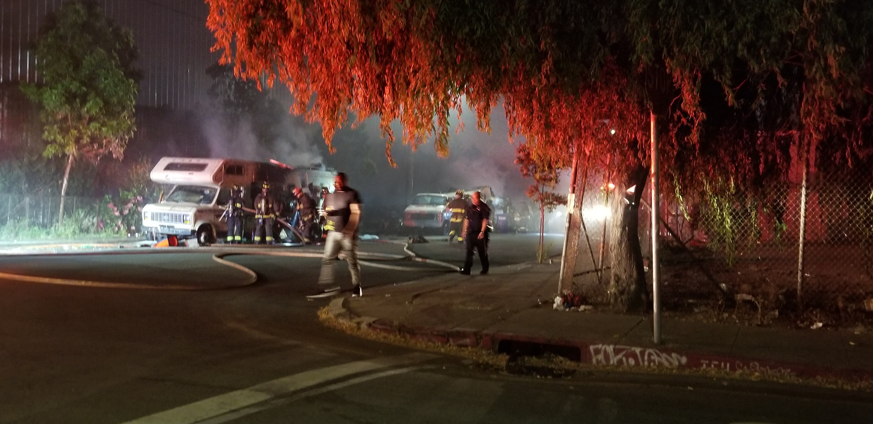 Oakland firefighters extinguish a fire in two RVs reportedly set by masked men in West Oakland on Aug. 2, 2019. Photo courtesy Jessica Brown.