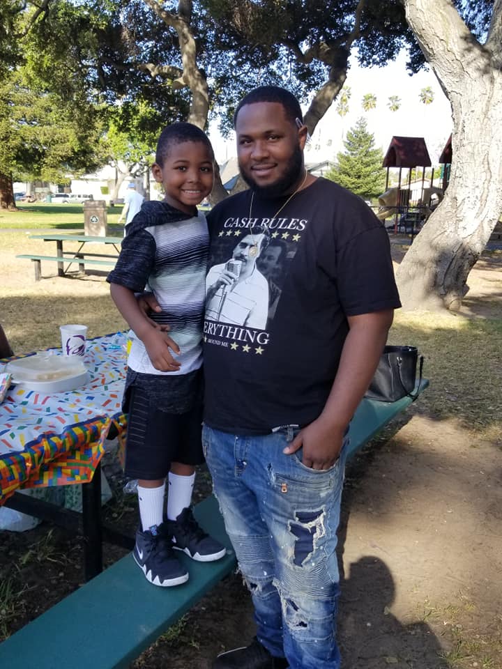 Dujuan Armstrong and his son. Photo courtesy of Barbara Doss.