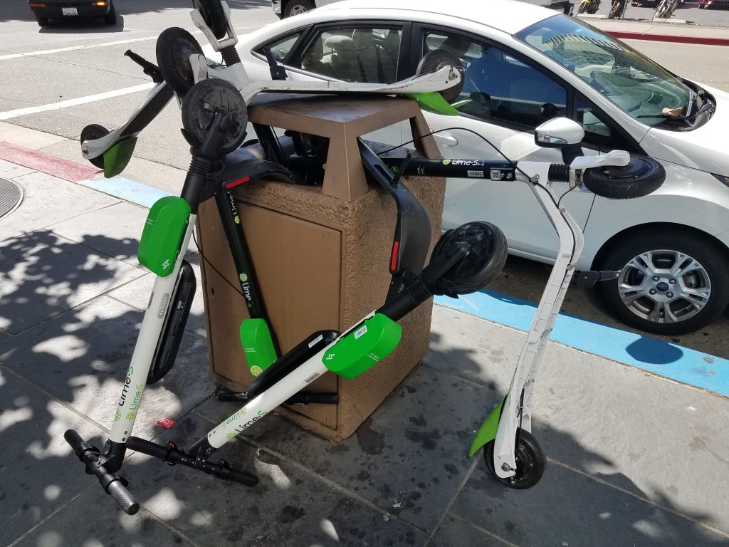 Scooters in a trash can in downtown Oakland. Photo by Scott Morris.