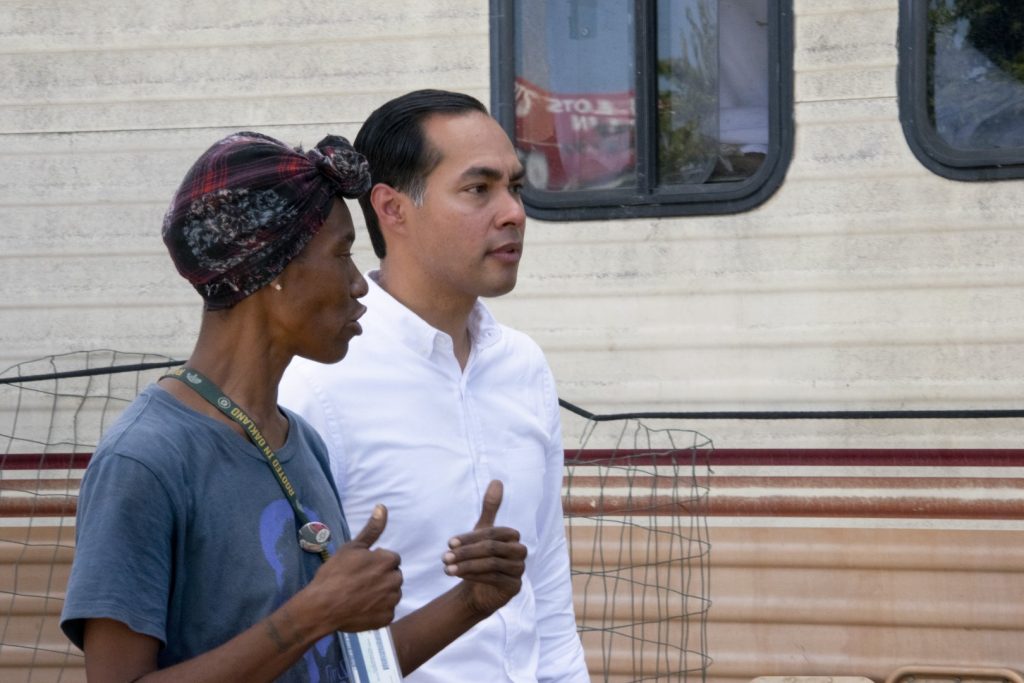 Democratic Presidential Candidate Julián Castro speaks to Markayla Spice, a resident of an Oakland homeless encampment, on Sept. 25. Photo by Scott Morris