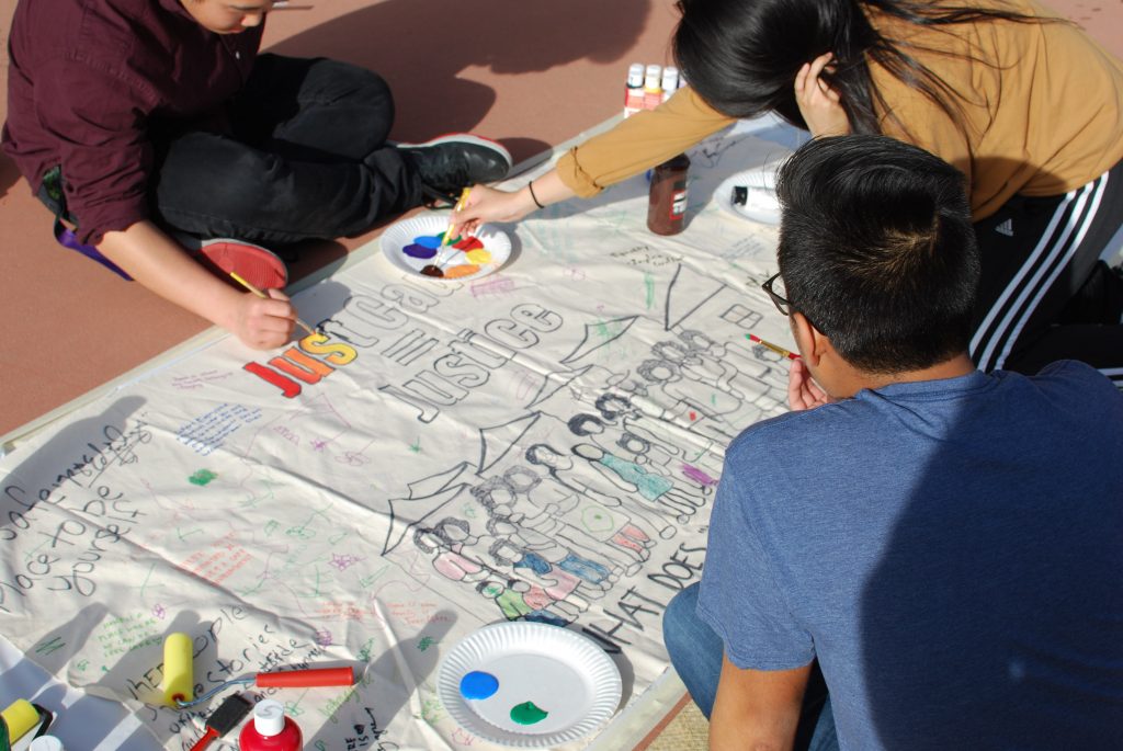 Protesters paint signs outside an Alameda City Council meeting on April 4. Photo by Scott Morris.