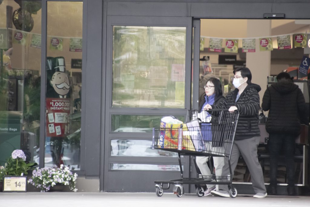 A couple exits a Safeway store in North Oakland on March 23, 2020. Photo by Scott Morris.