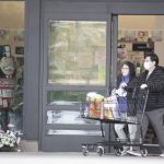 A couple exits a Safeway store in North Oakland on March 23, 2020. Photo by Scott Morris.
